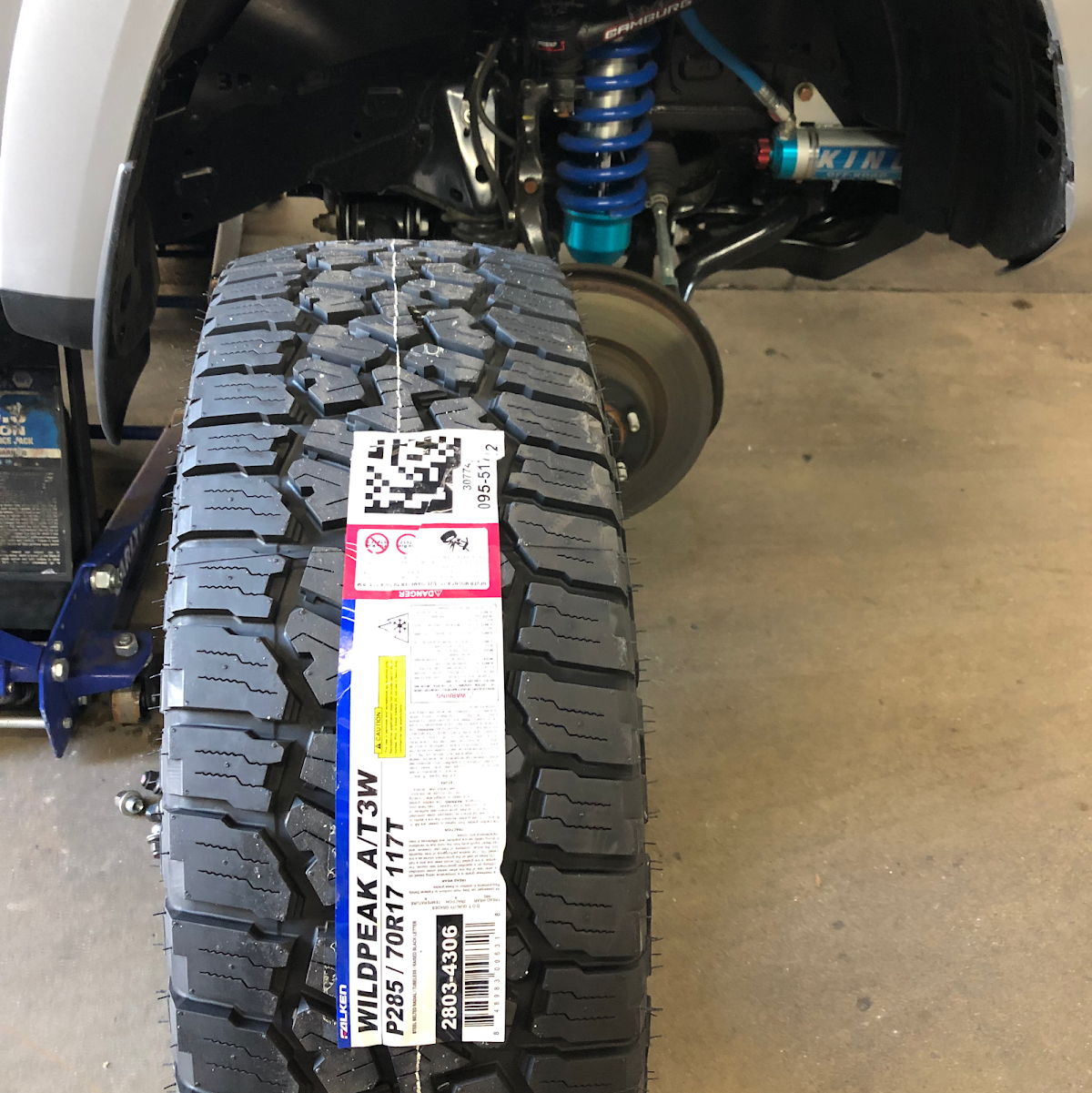 A Falken Wildpeak all terrain tire being fitted to a lifted truck at Southland Automotive